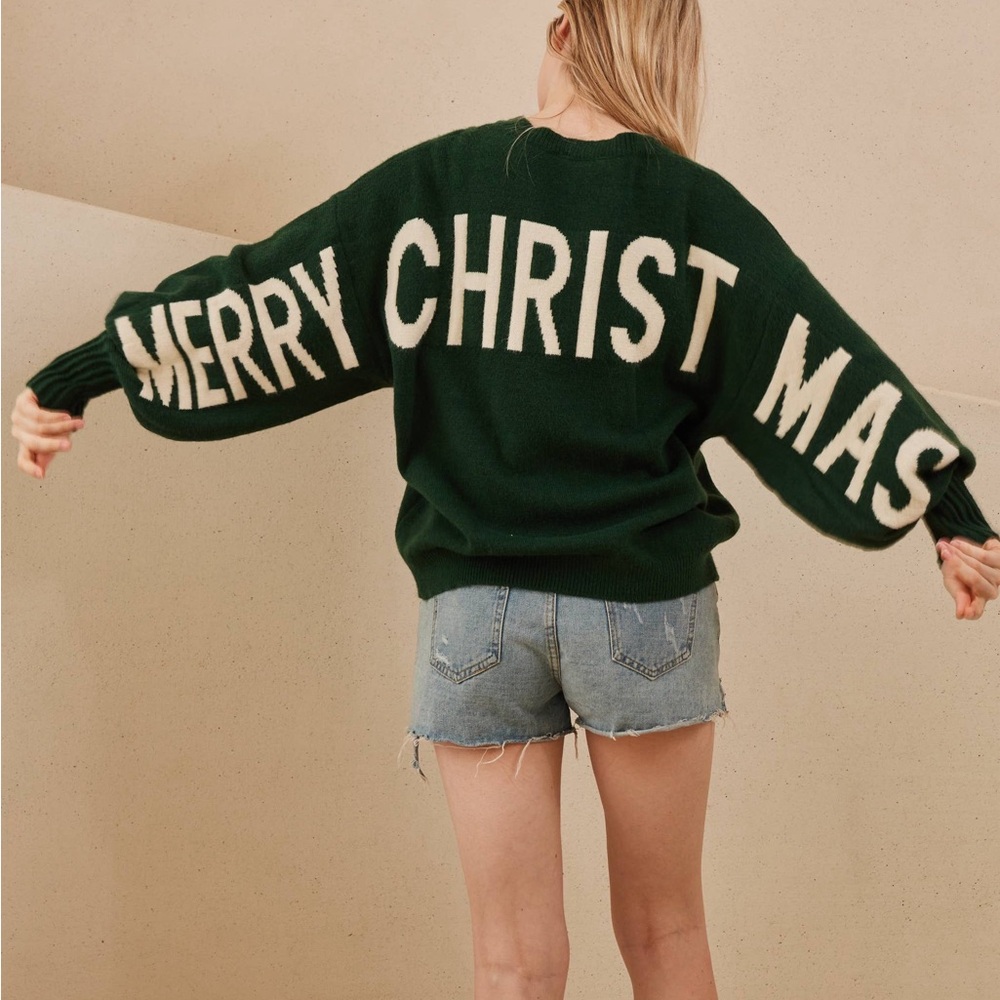Christmas Sweater with Merry Christmas lettering across the sleeves and back.